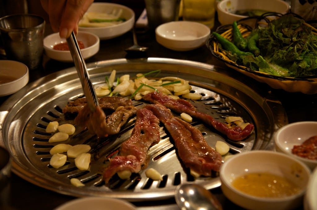 Strips of sizzling steak on a Korean barbecue.