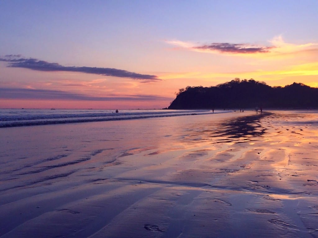 Purple and yellow sunset on the beach in Samara, Costa Rica.