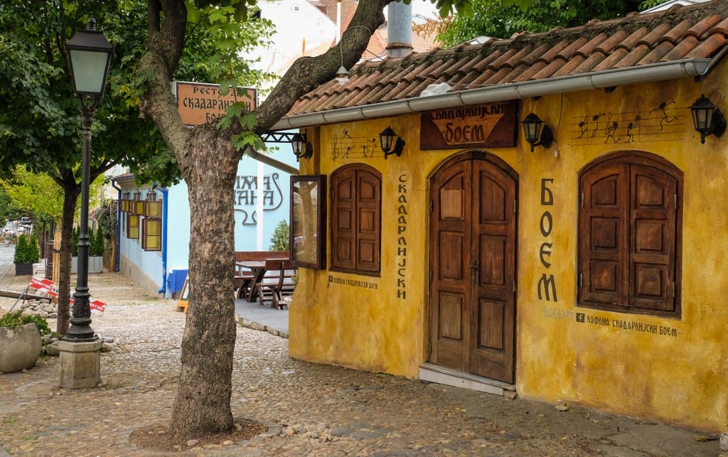 A yellow house on a cobbled street in Belgrade