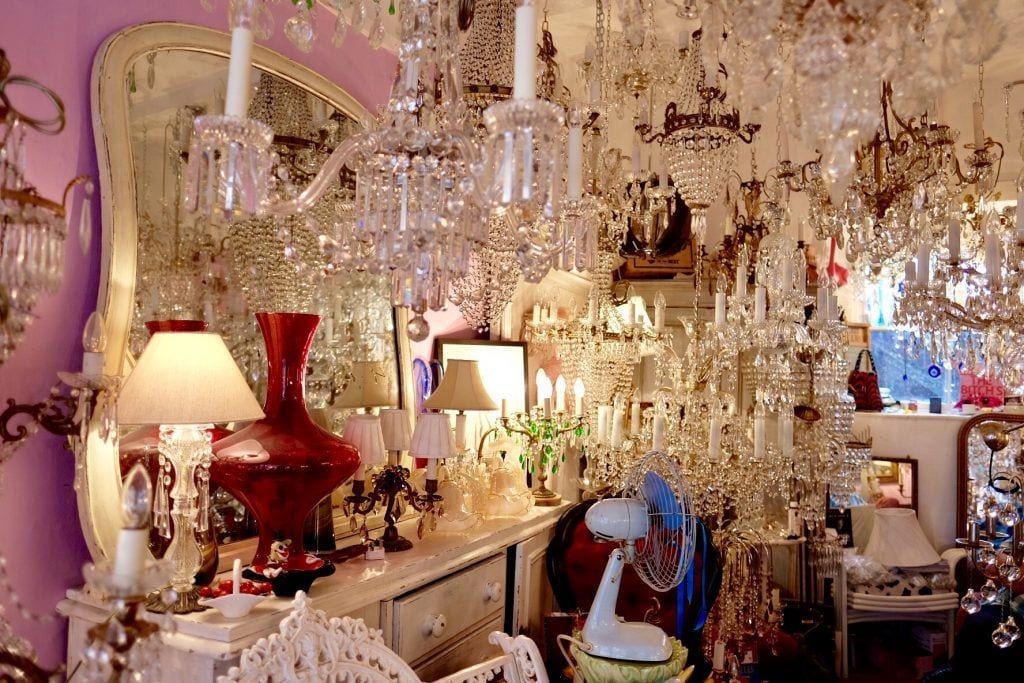 A store full of crystal chandeliers hanging from the ceiling.
