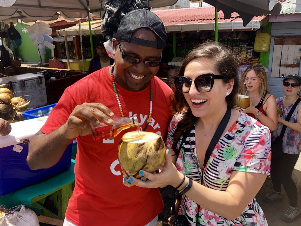 Kate and Delvin sharing a coconut in Georgetown, Guyana