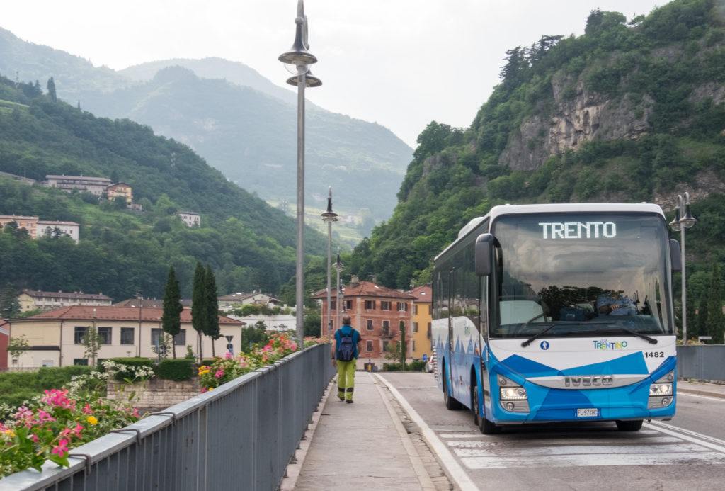 A bus crosses a bridge in Trento, Italy