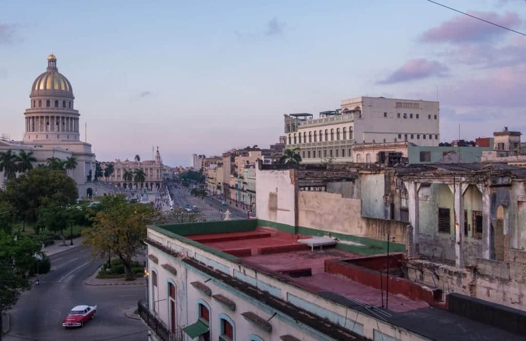 View of the Capitol building and the streets of Havana after sunset.