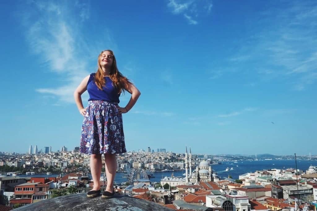 Katie standing on a rooftop in Istanbul underneath a blue sky.